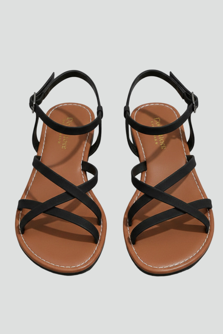 Chic women's flat sandals with criss-cross straps, ideal for summer comfort & style. Open toe casual footwear.