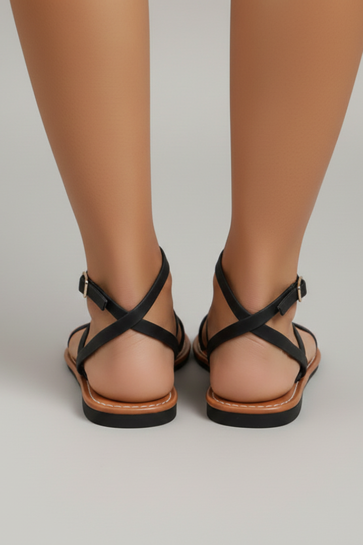 Chic and comfortable women's flat sandals with criss-cross straps. Essential open-toe summer casual footwear.