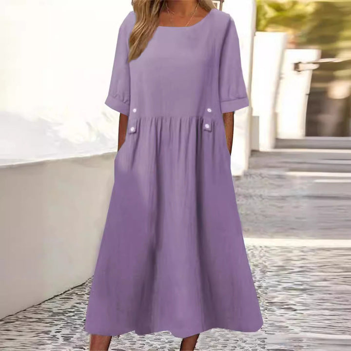 Chic women's flowy summer midi dress with a relaxed fit, round neck, and sleeveless design, perfect for vacation.