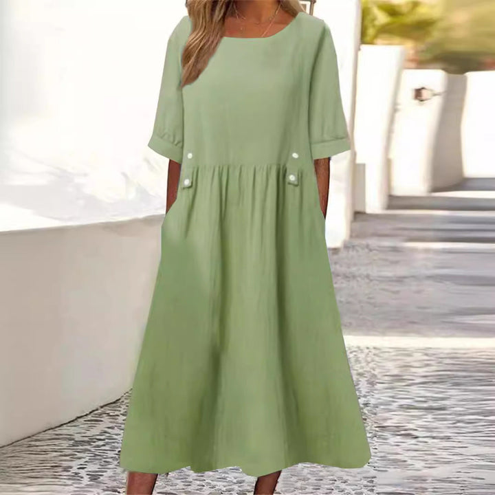 Relaxed fit women's chic flowy summer midi dress. Comfortable sleeveless design with a round neck, ideal for vacation wear.