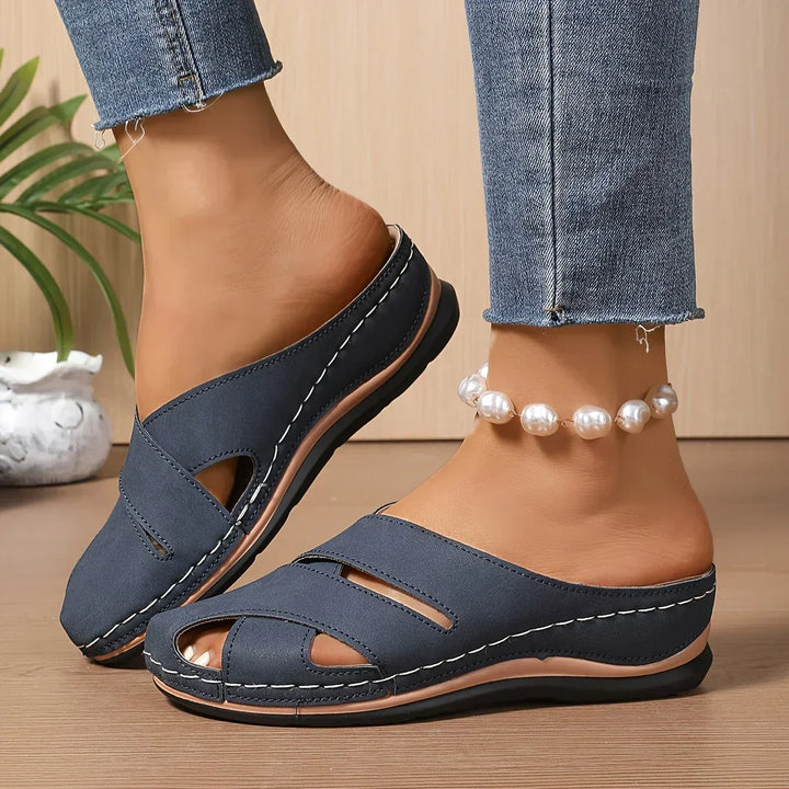 Chic women's platform wedge sandals in black, offering elevated style and comfortable support for everyday wear.