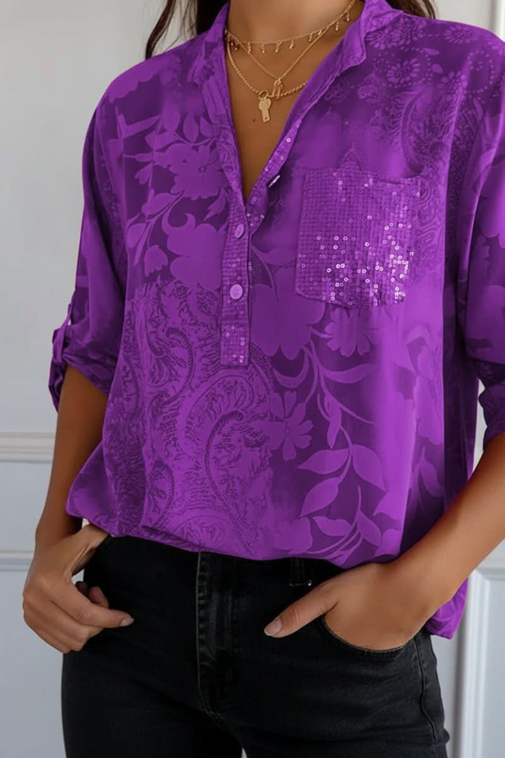 Fashionable women's long sleeve printed top with a chic design and practical front pocket for casual outings.