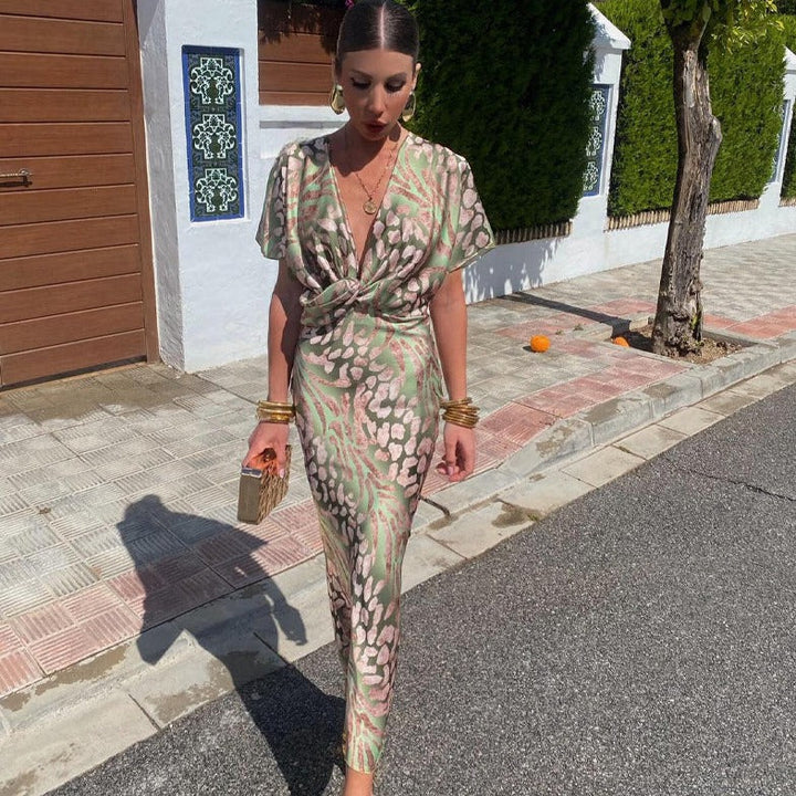 Chic women's printed maxi wedding guest dress with a stylish twist front and elegant V-neck for formal occasions.