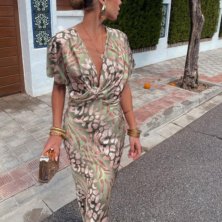 Sophisticated printed maxi formal dress for women, ideal for wedding guests or special occasions, with a chic twist front.