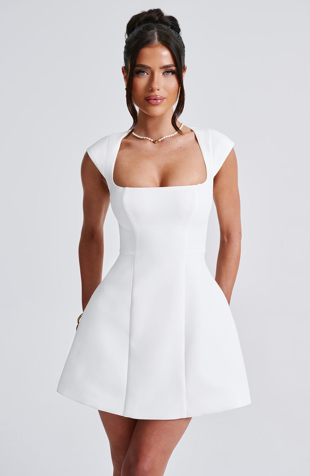 Chic women's sleeveless mini dress for modern elegance. Perfect versatile tailored dress for parties or casual wear.