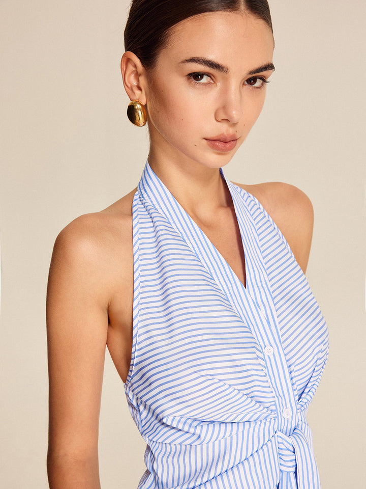 Fashionable women's striped halter blouse with a chic tie front. Elegant sleeveless top, ideal for professional or casual outfits.
