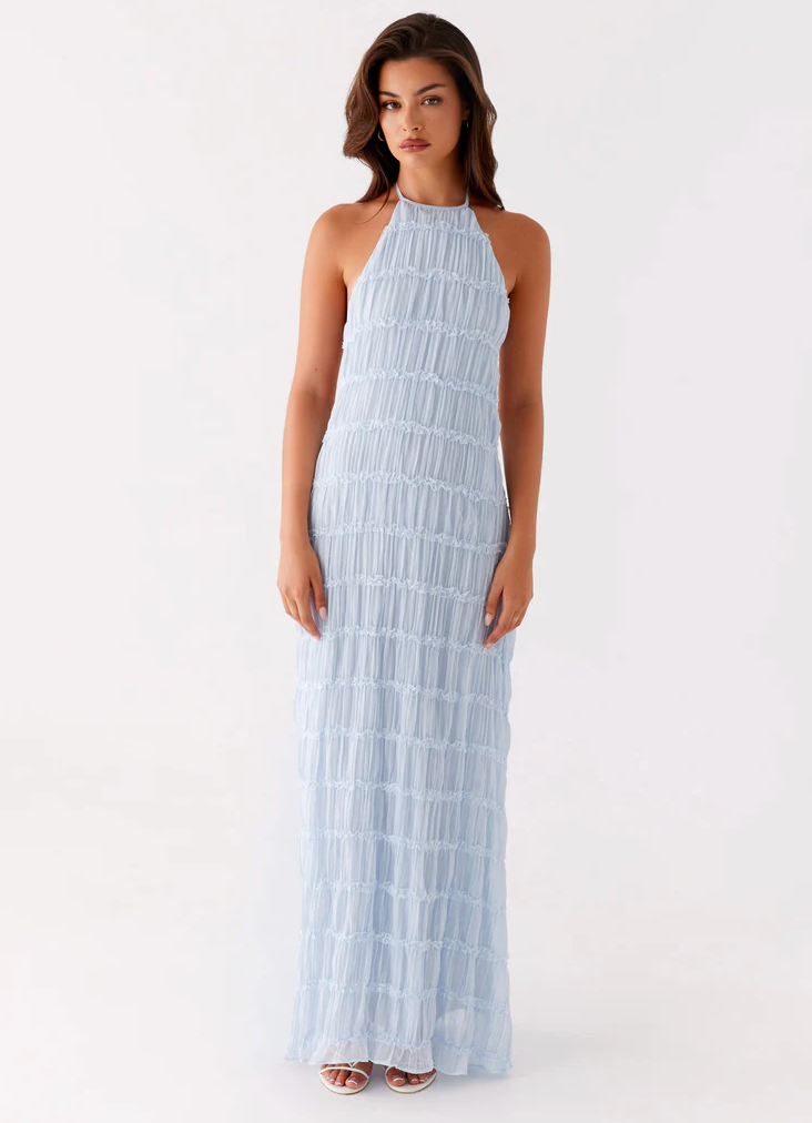Stylish open-back halter maxi wedding guest dress. Long, textured, and perfect for formal events.