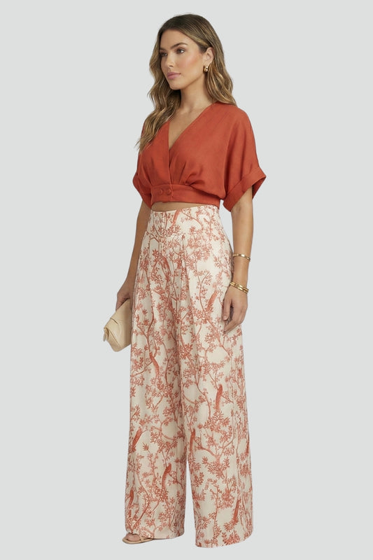 Relaxed fit V-neck top and fashionable wide leg patterned pants. Women's two-piece set for ultimate summer comfort.