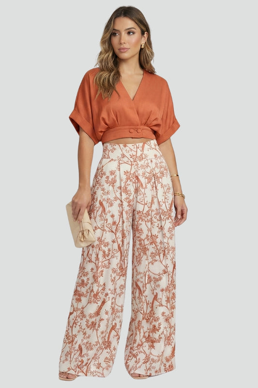 Trending women's V-neck two-piece set with chic wide leg patterned trousers. A complete summer outfit for effortless style.