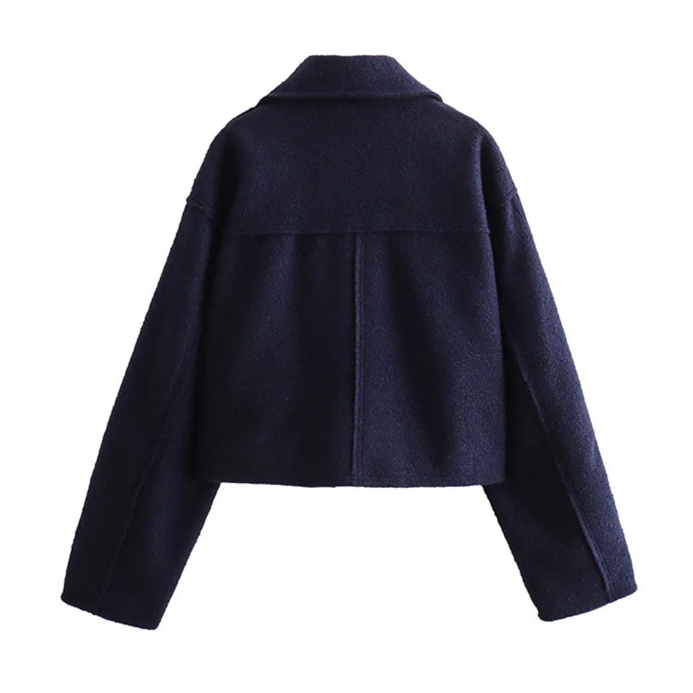 close-up of the wool-blend fabric on a women's bomber jacket, showing texture and quality