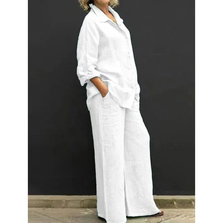 Comfortable black two-piece women's set: long-sleeve button-up shirt and high-waist wide-leg pants.