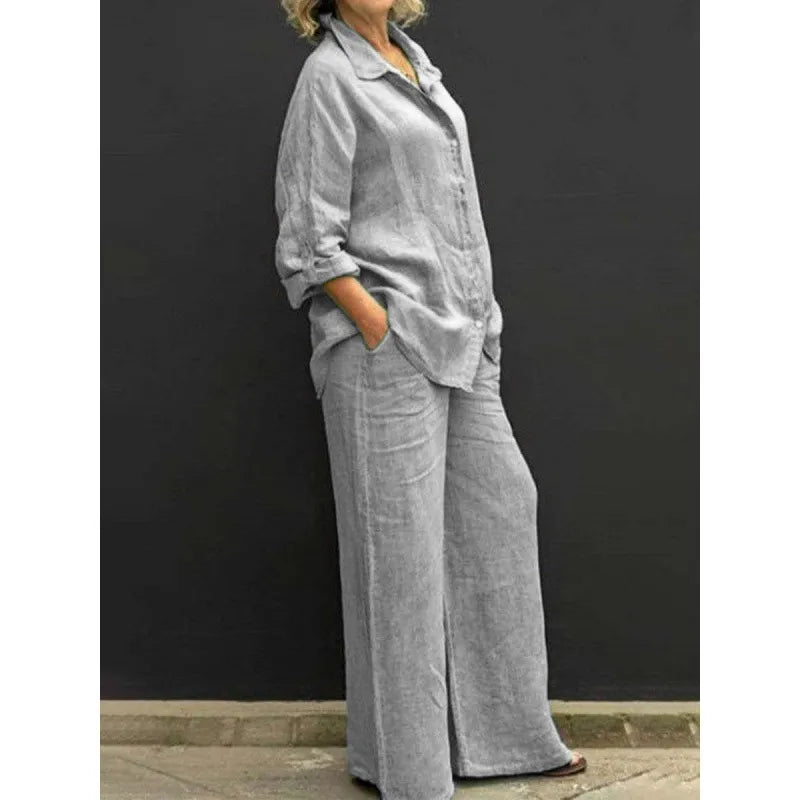 White spring/summer women's matching set: relaxed button-up shirt & flattering wide-leg pants. Effortless style.