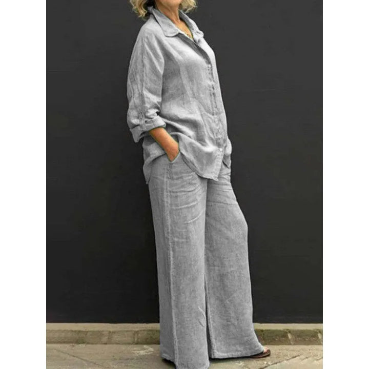 White spring/summer women's matching set: relaxed button-up shirt & flattering wide-leg pants. Effortless style.