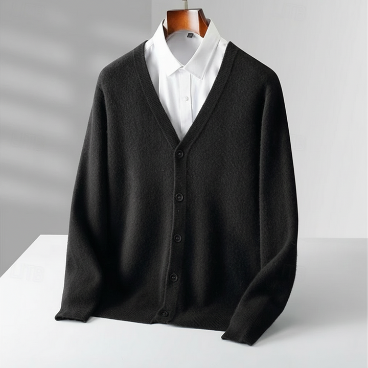 Detail of a men's classic V-neck cardigan, highlighting soft knit fabric and brown buttons. Timeless all-season wear.