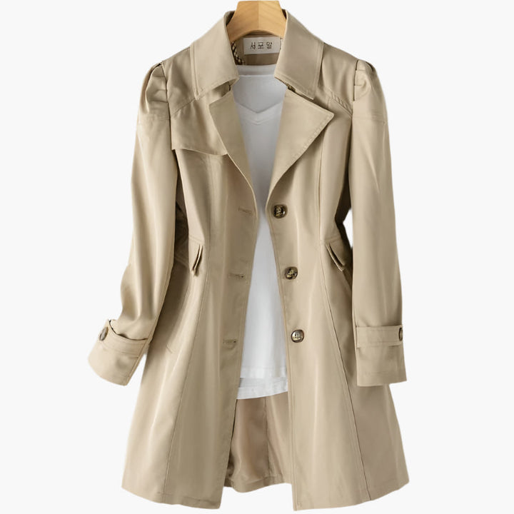 Tailored women's trench coat, a classic outerwear piece designed for a sophisticated, elegant look. Long length.