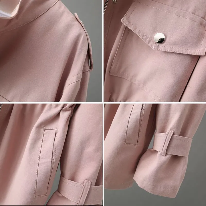 Close-up of a women's classic trenchcoat showing the belted waist, notch collar, and structured fabric.