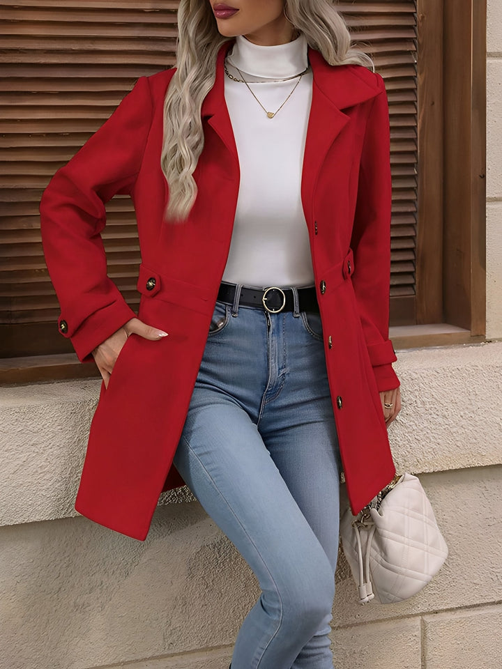 Stylish women's long trench coat, double-breasted with a cinched belted waist, suitable for everyday elegance.