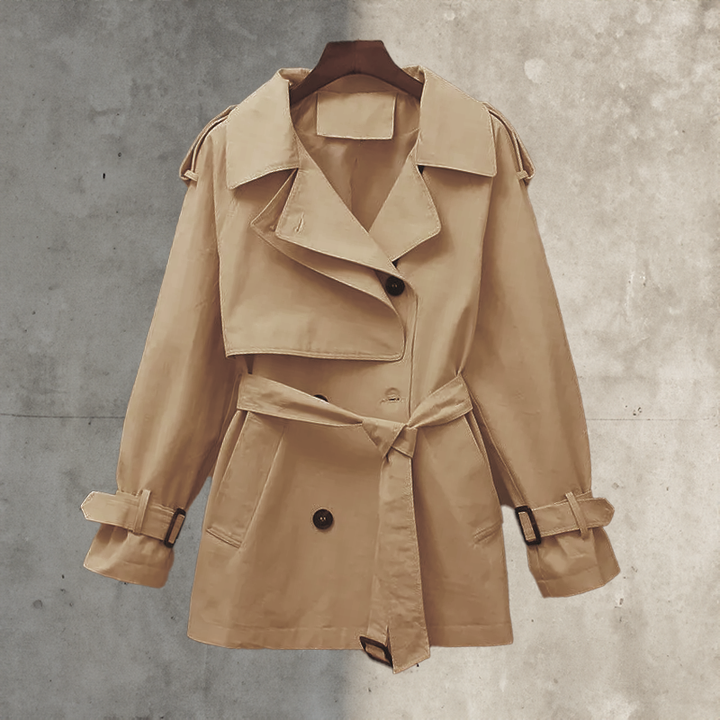 Elegant women's belted trench coat, double-breasted design, perfect transitional outerwear for office or casual chic.
