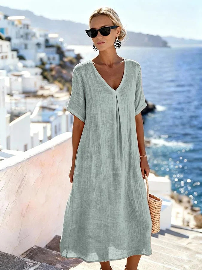 Vibrant Women's Summer Midi Dress with short sleeves & V-neck, perfect for a relaxed travel look.