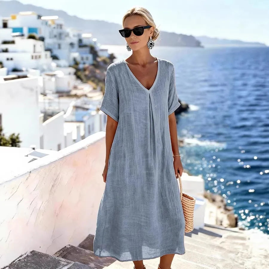 Women's casual V-Neck Midi Dress with short sleeves in a vibrant color, perfect for beach days.