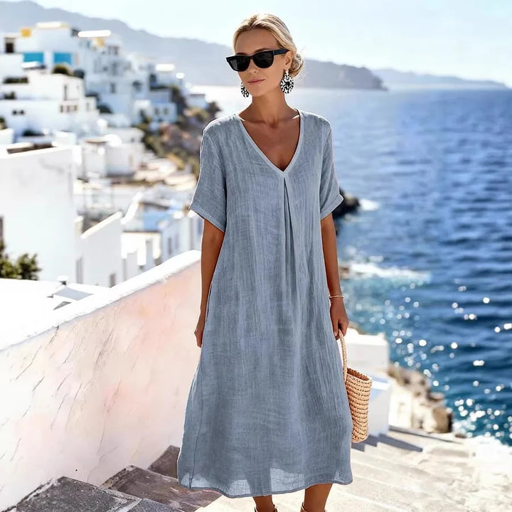 Women's casual V-Neck Midi Dress with short sleeves in a vibrant color, perfect for beach days.