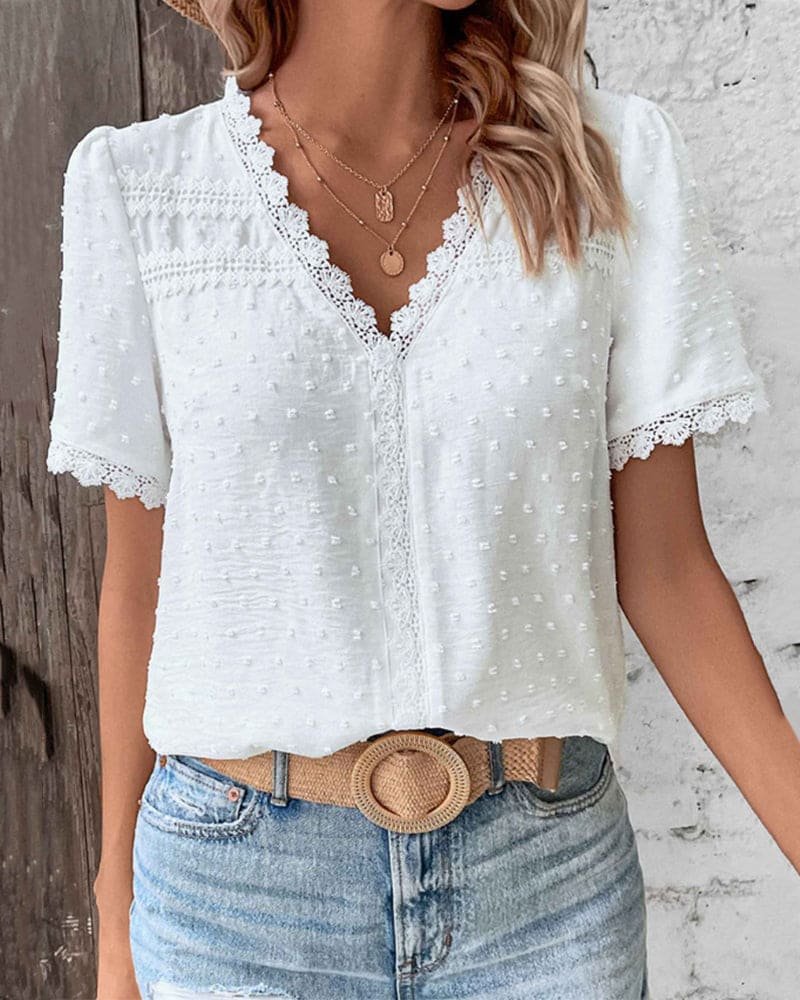 Close-up of a Women's Swiss Dot V Neck Top with delicate lace trim, showcasing the fabric detail.