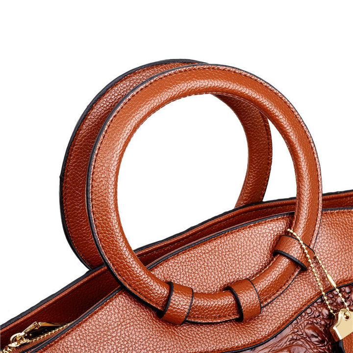 Front and side view of a women's vintage croc embossed faux leather handbag, elegant style.