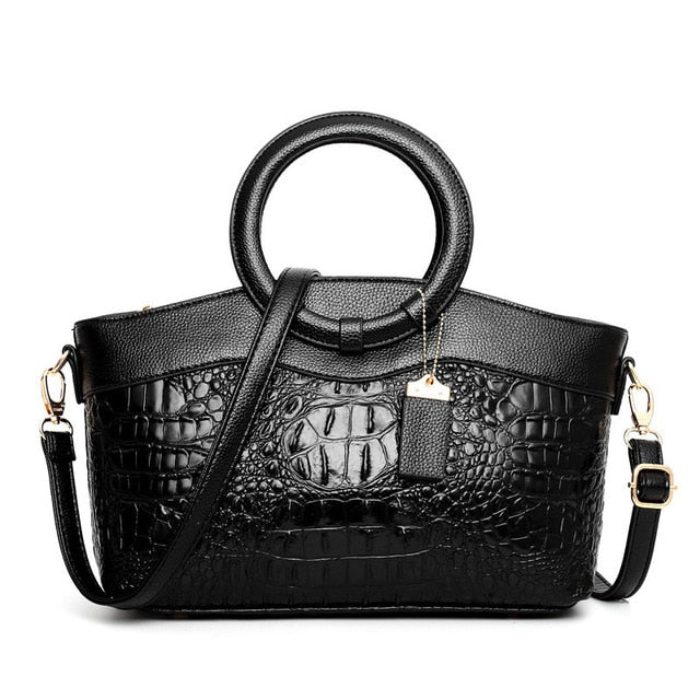 Lady's elegant black croc embossed vintage handbag, versatile for work or evening.
