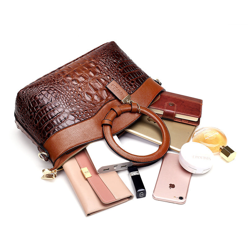 Front view of a stylish red croc embossed faux leather shoulder bag, versatile accessory.