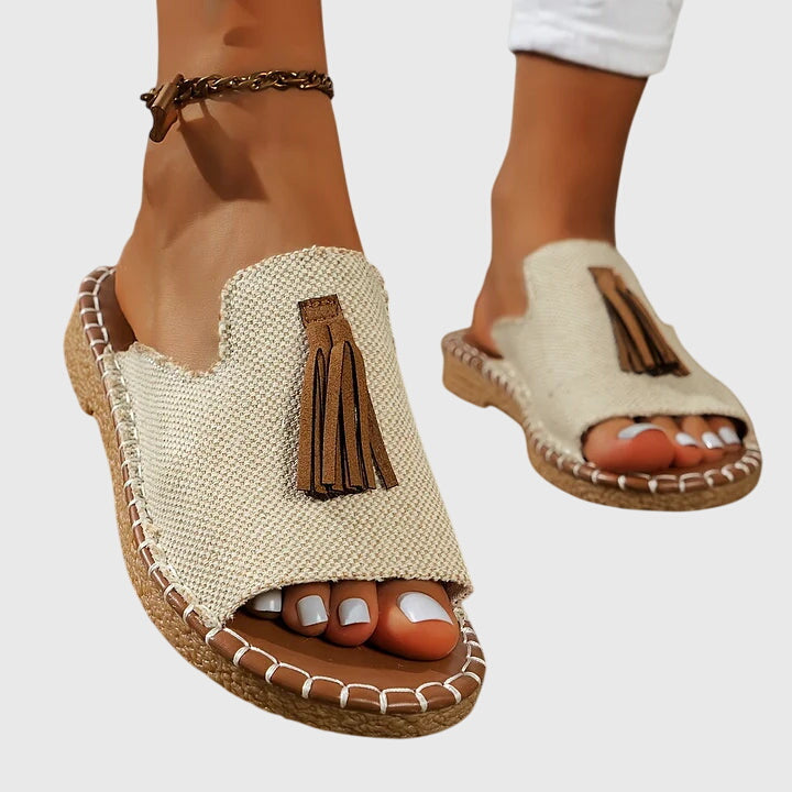 Women's summer footwear: comfortable casual sandals with eye-catching tassel straps and open toe design.