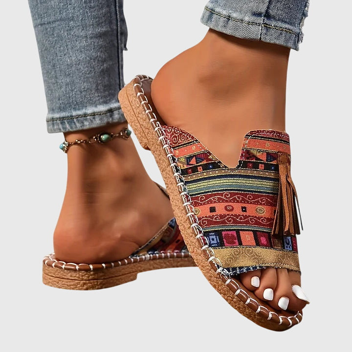 Stylish women's slip-on sandals, designed for comfort with fashionable tassels, great for vacation.