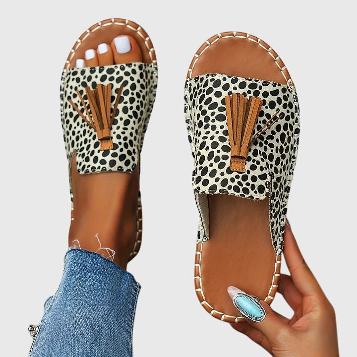 Front view of women's casual flat sandals, featuring comfortable design and stylish tassel straps.