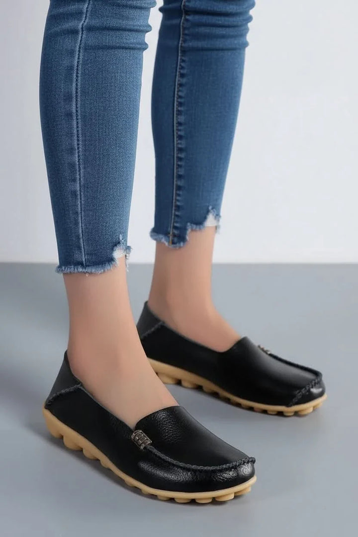 Close-up of women's cushioned round toe flat shoe, emphasizing comfort & slip-on design.