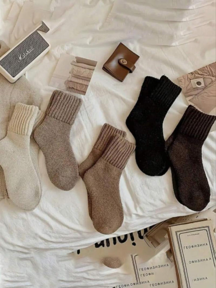 Close-up of women's warm wool blend knit socks in a neutral beige, highlighting cozy texture