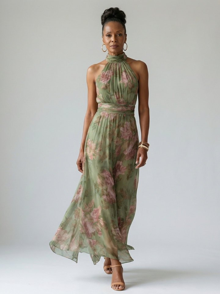 Full shot of a model wearing an elegant women's green floral print halter midi dress, ideal for summer.