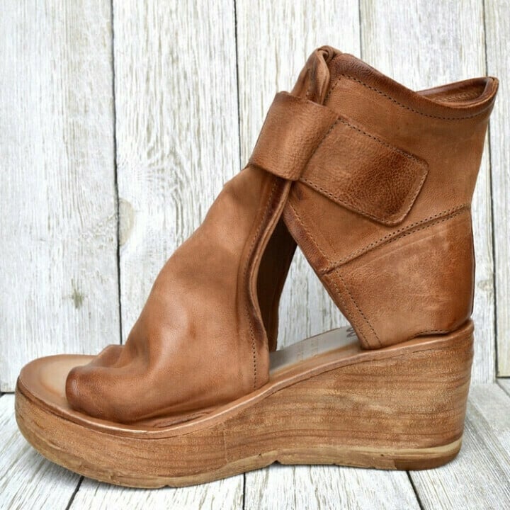 Pair of women's boho wedge sandals, comfortable, stylish, and adjustable summer footwear with buckle.