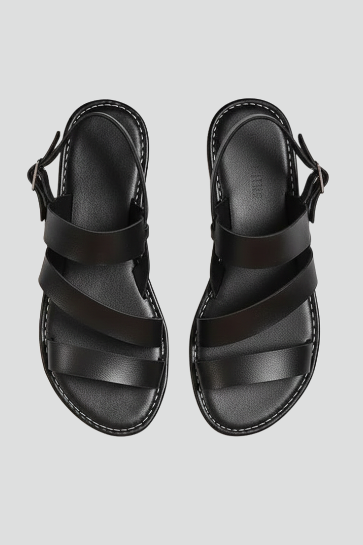 Comfortable women's flat sandals with secure back strap, perfect for everyday summer style.