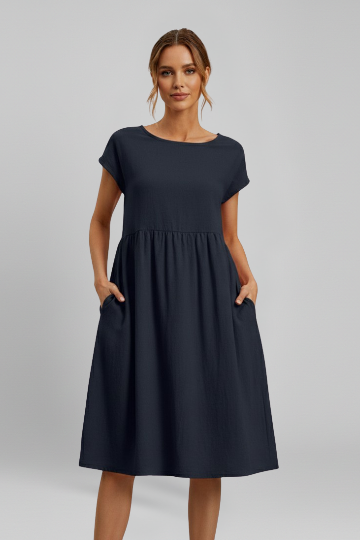 Everyday chic women's knee-length dress featuring a round neck, short sleeves, and practical pockets.