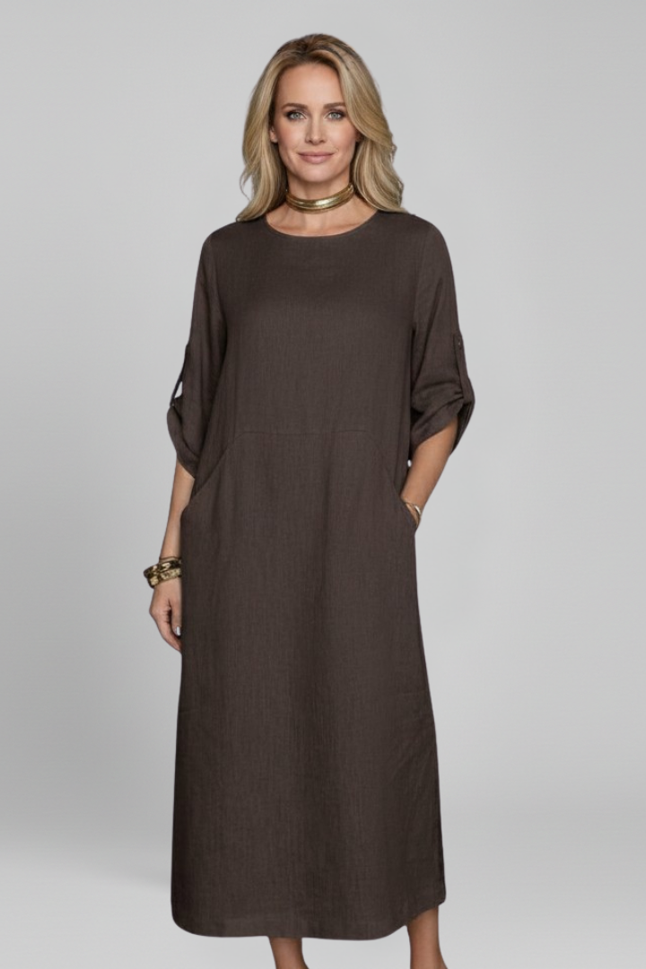 Stylish women's casual knee-length dress with a relaxed fit, round neck, short sleeves, and pockets.