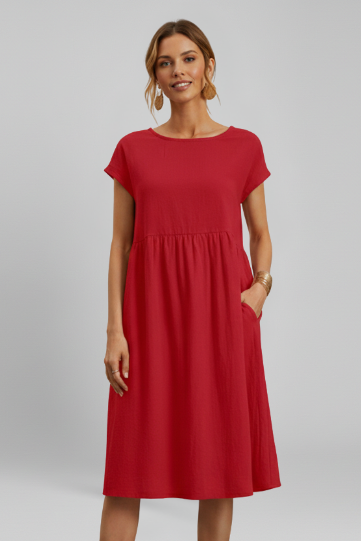 Relaxed fit women's knee-length dress, round neck, short sleeves, and practical pockets for versatile wear.