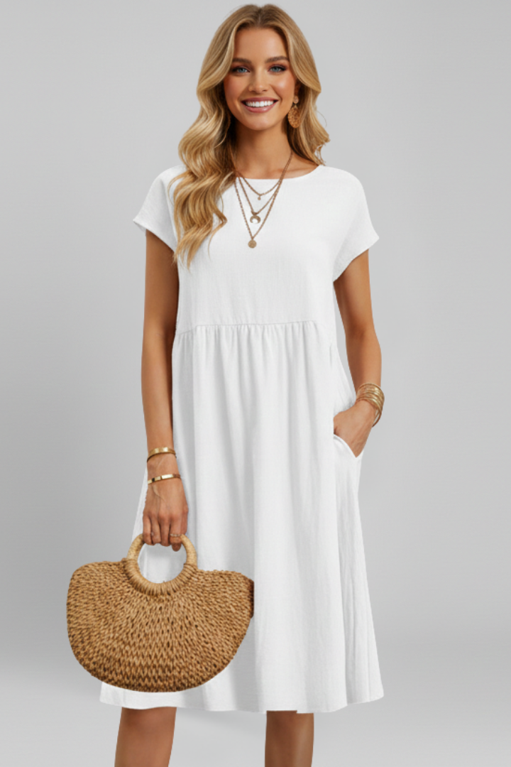 Flattering women's relaxed fit knee-length dress, featuring a round neck, short sleeves, and pockets.