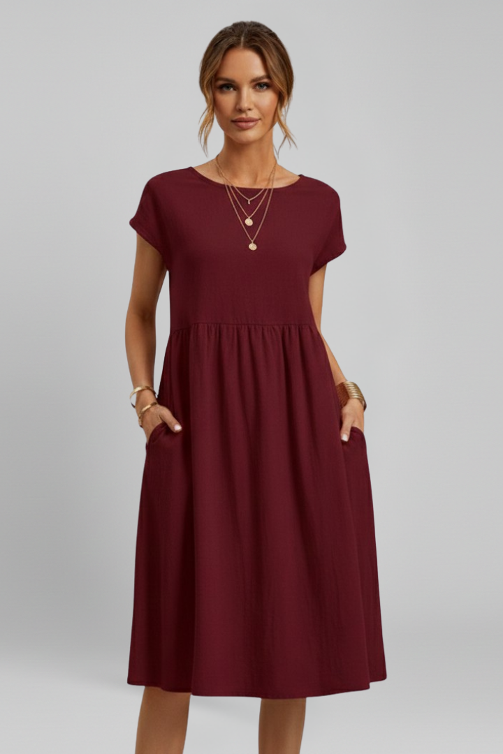 Relaxed fit women's casual knee-length dress with a round neck, short sleeves, and handy pockets.