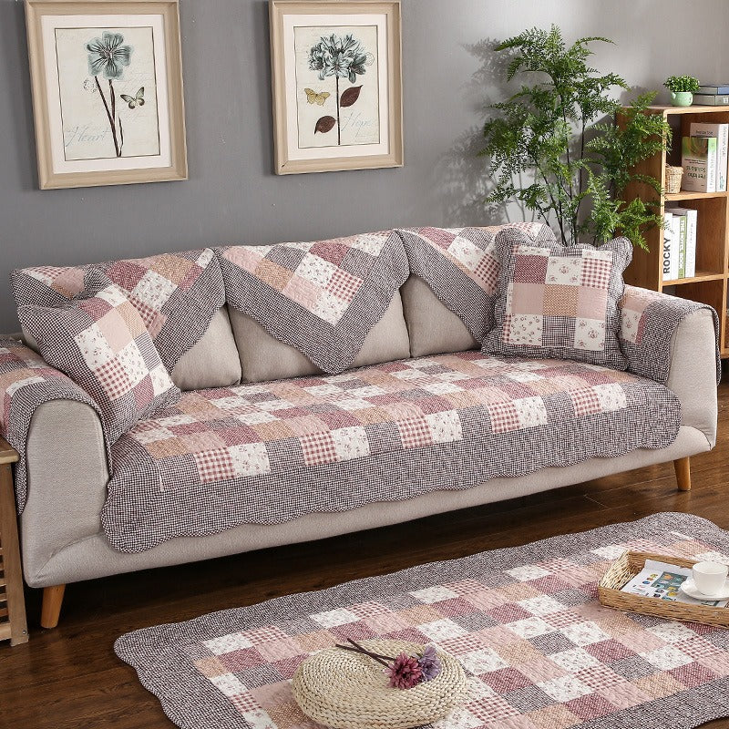 Cotton quilted sofa cover in a living room, featuring a non-slip, washable design for furniture protection.