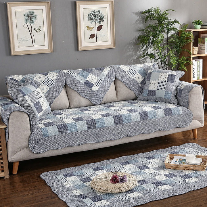 Washable cotton quilted couch cover, showcasing its non-slip backing for effective furniture protection.