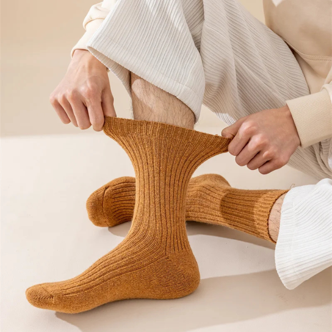 Pair of thick grey wool winter socks, ready for cozy comfort and ultimate warmth.
