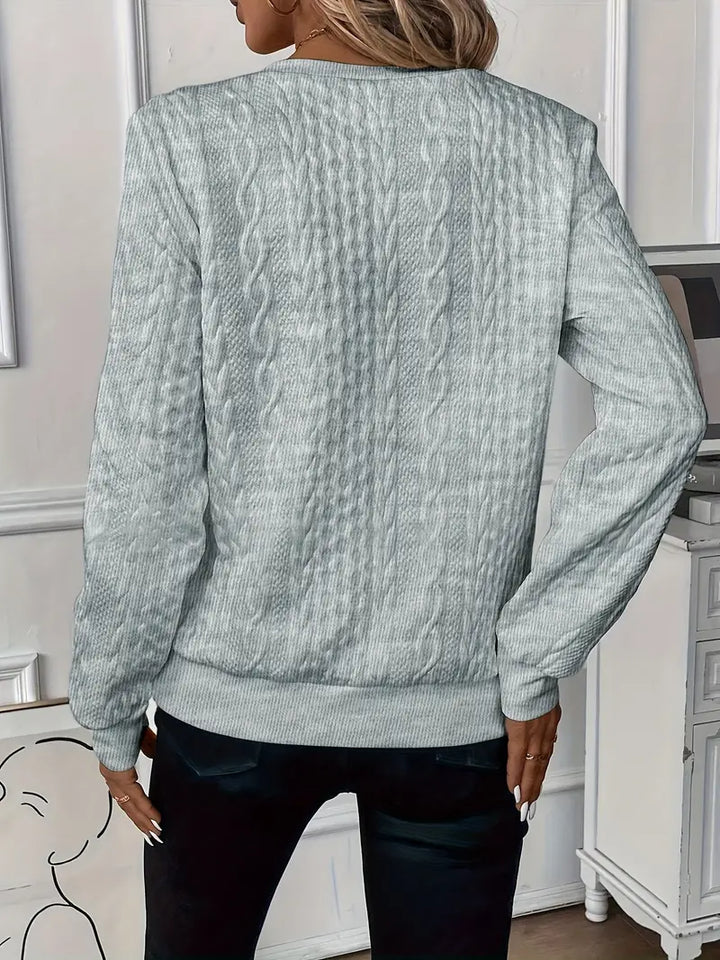 Women's cozy zippered sweater styled with jeans, perfect for a relaxed yet trendy look.