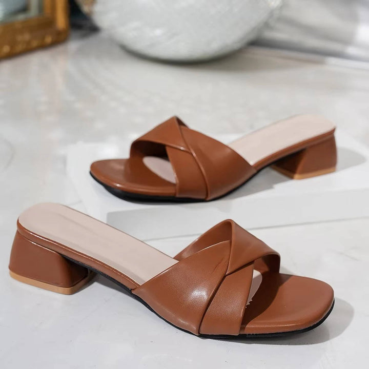 Stylish open-toe, square-toe women's slide sandals with a comfortable block heel and versatile cross straps.