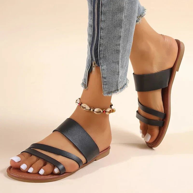 Women's cushioned cross-strap flat sandals for comfortable everyday summer wear.