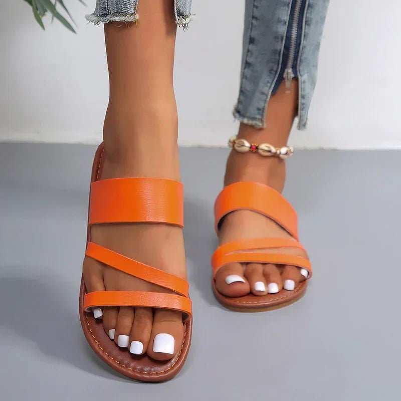 Fashionable women's cross-strap flat sandals, cushioned for all-day comfortable wear.