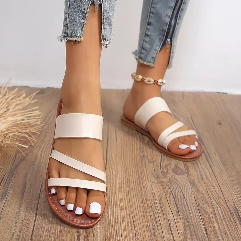 Chic women's cross-strap flat sandals, perfect slip-on summer shoes for versatile style.